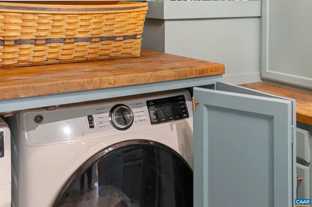 a kitchen with a sink and a stove with chairs