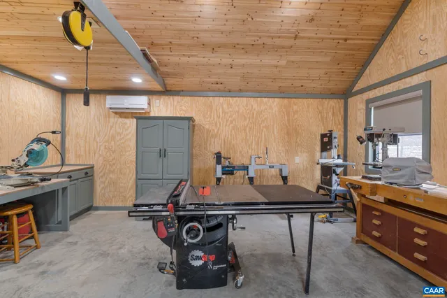 a kitchen with a table chairs stove and cabinets