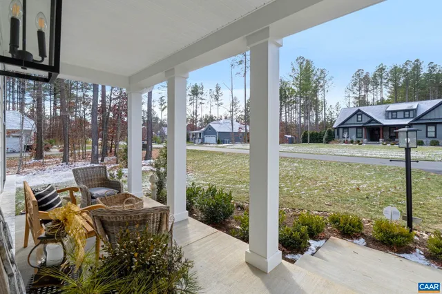 a view of a patio with table and chairs potted plants with wooden floor