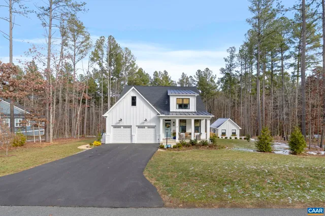 a backyard of a house with outdoor seating