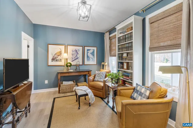 a living room with furniture a window and a flat screen tv