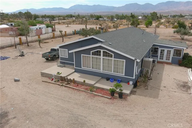 an aerial view of a house with a yard and lake view