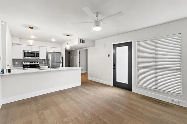 a view of kitchen with stainless steel appliances refrigerator stove microwave and cabinets