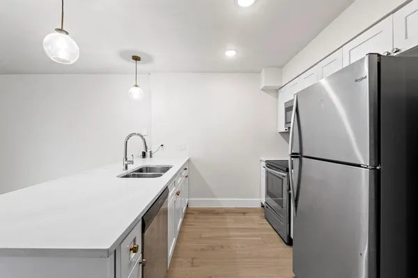 a kitchen with stainless steel appliances a refrigerator and a sink