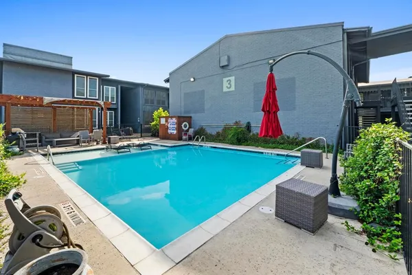a view of a backyard with furniture and a fire pit