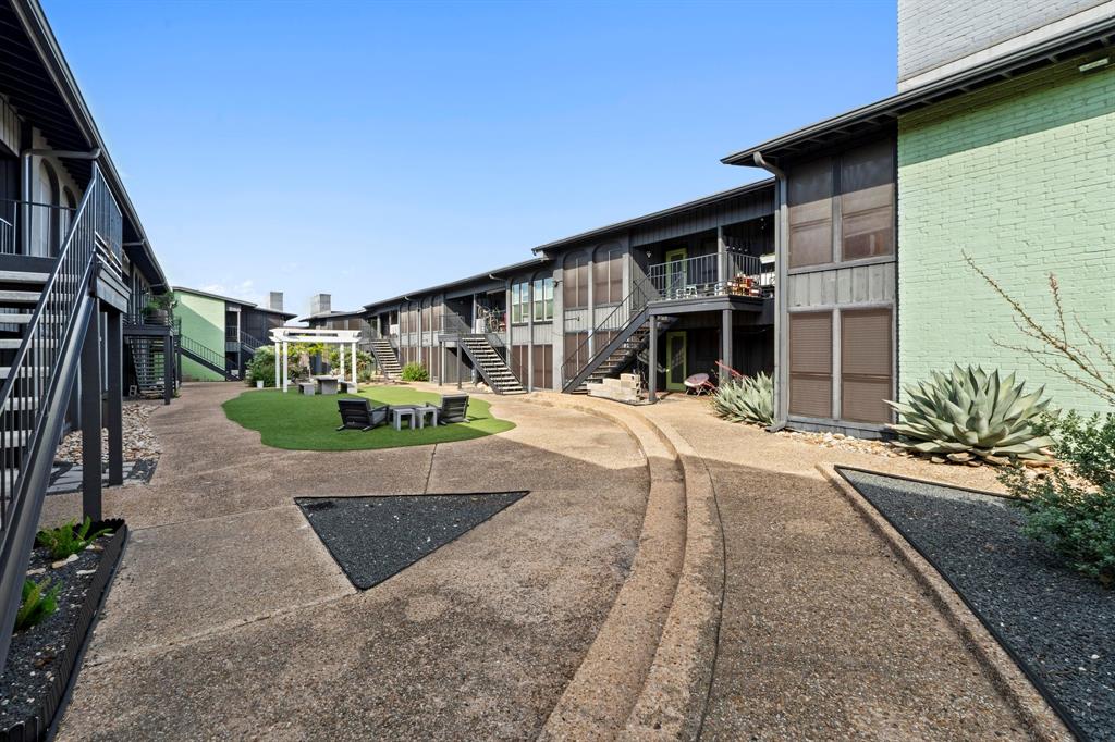 909 Reinli Street, Unit 101 Austin, TX 78751 - Photo 27 of 34 a front view of a house with a yard and potted plants