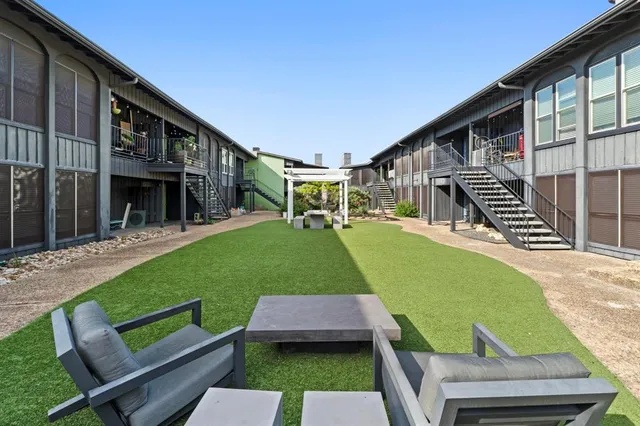 a view of a backyard with sitting area