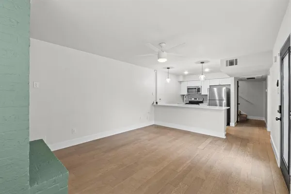 a view of kitchen with kitchen island sink and refrigerator