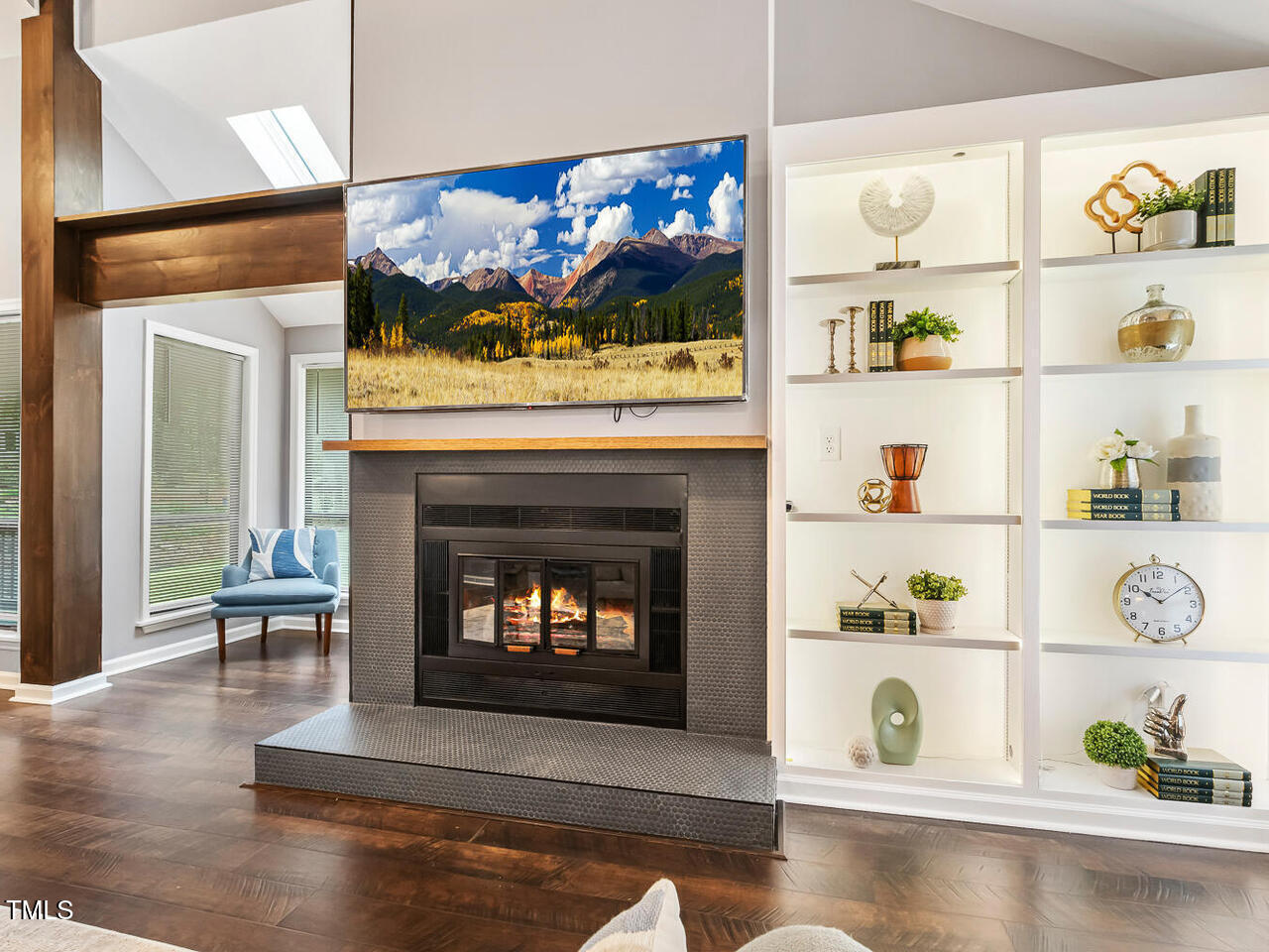 3900 Maplefield Drive Raleigh, NC 27613 - Photo 14 of 58 a living room with a fireplace and a flat screen tv