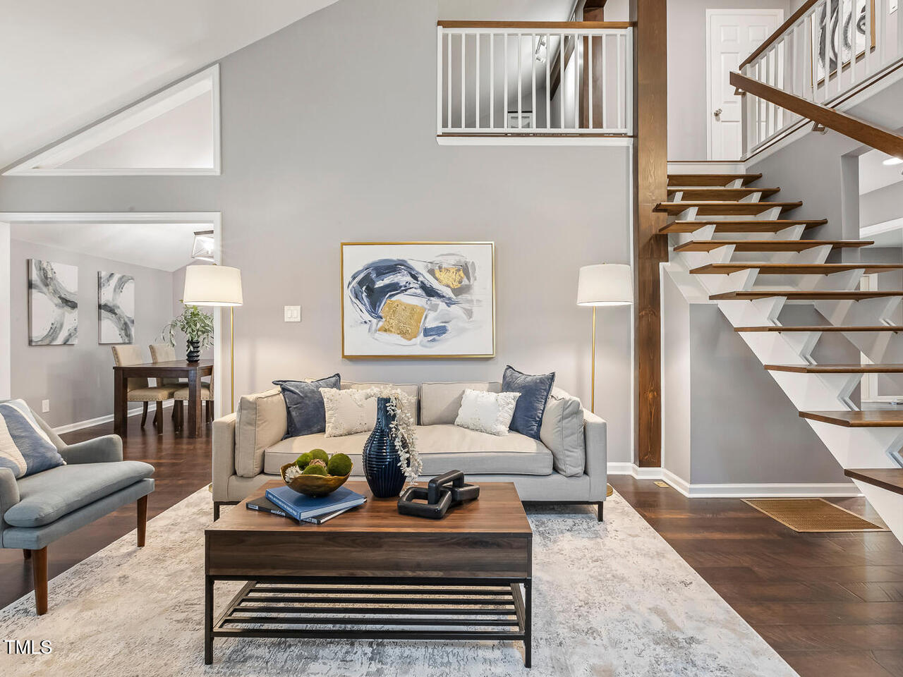 3900 Maplefield Drive Raleigh, NC 27613 - Photo 17 of 58 a living room with furniture and a wooden floor