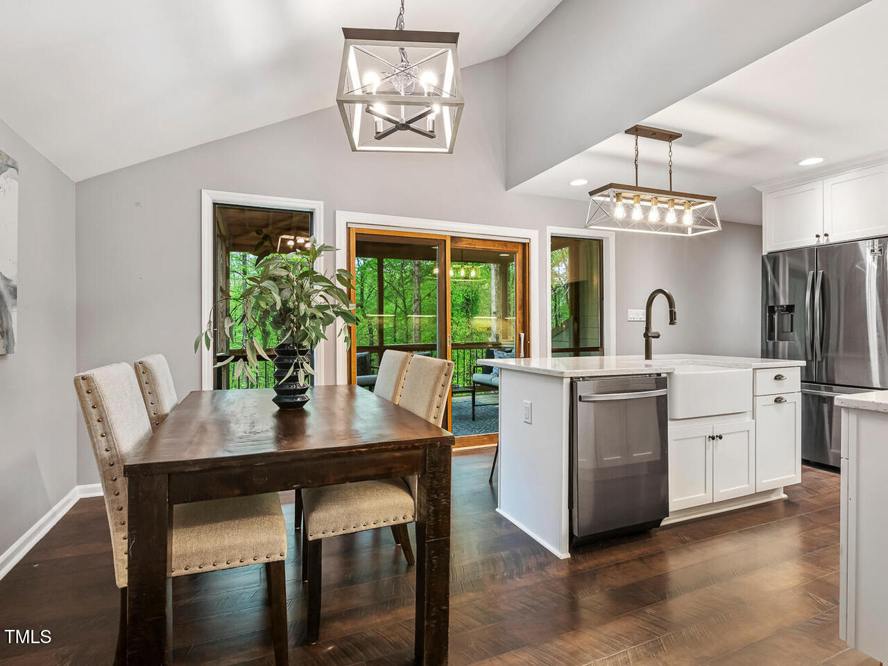 3900 Maplefield Drive Raleigh, NC 27613 - Photo 18 of 58 a kitchen with stainless steel appliances granite countertop a table chairs and stove