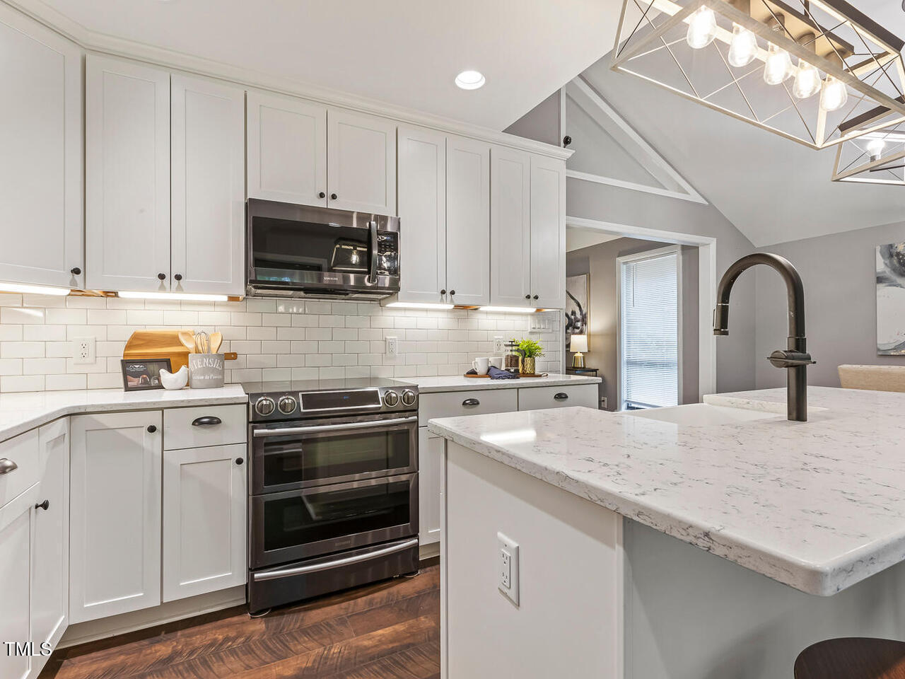 3900 Maplefield Drive Raleigh, NC 27613 - Photo 24 of 58 a kitchen with granite countertop a stove and a sink