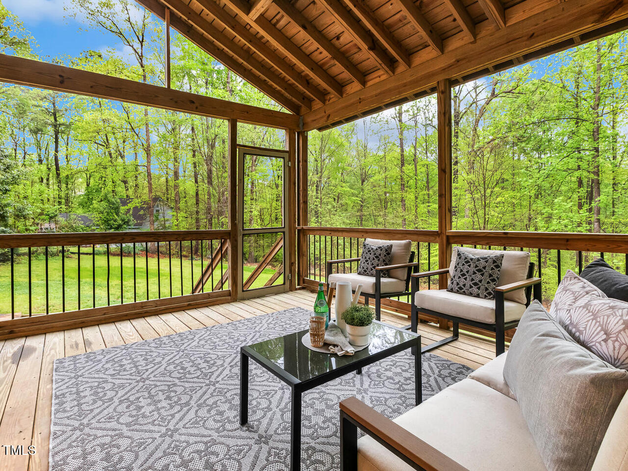3900 Maplefield Drive Raleigh, NC 27613 - Photo 31 of 58 a living room with furniture and a floor to ceiling window