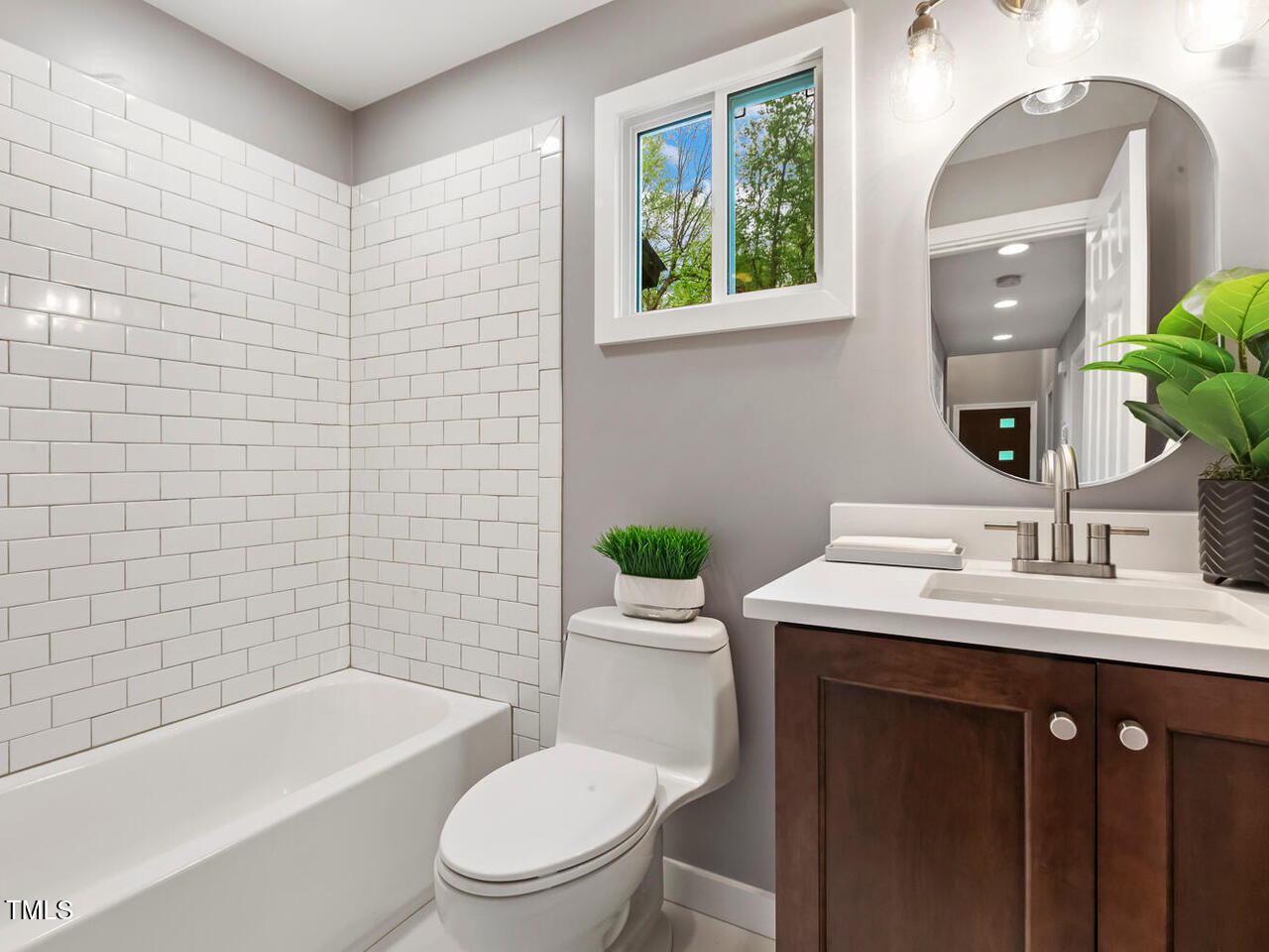 3900 Maplefield Drive Raleigh, NC 27613 - Photo 33 of 58 a bathroom with a sink a toilet and shower