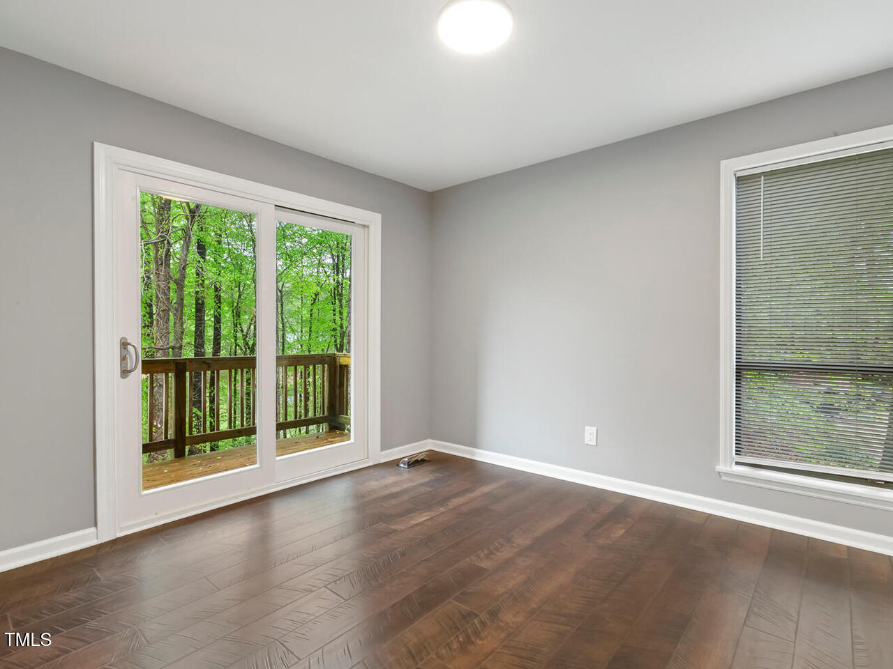3900 Maplefield Drive Raleigh, NC 27613 - Photo 34 of 58 a view of an empty room with wooden floor and a window