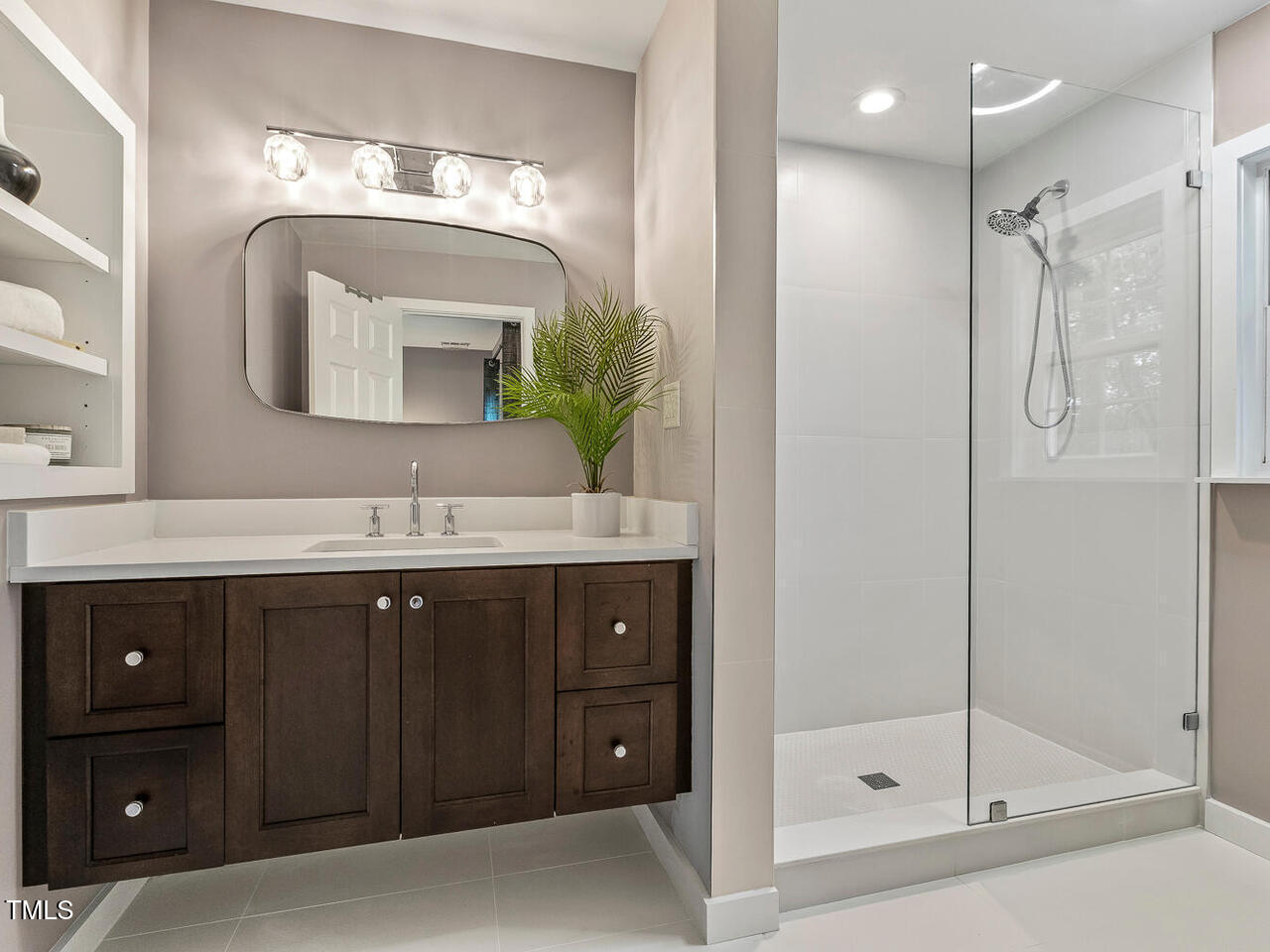 3900 Maplefield Drive Raleigh, NC 27613 - Photo 43 of 58 a bathroom with a double vanity sink mirror and shower