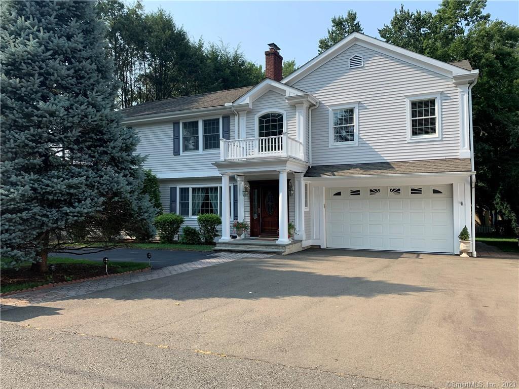 166 Vine Road Stamford, CT 06905 - Photo 1 of 1 a front view of a house with a garden and trees