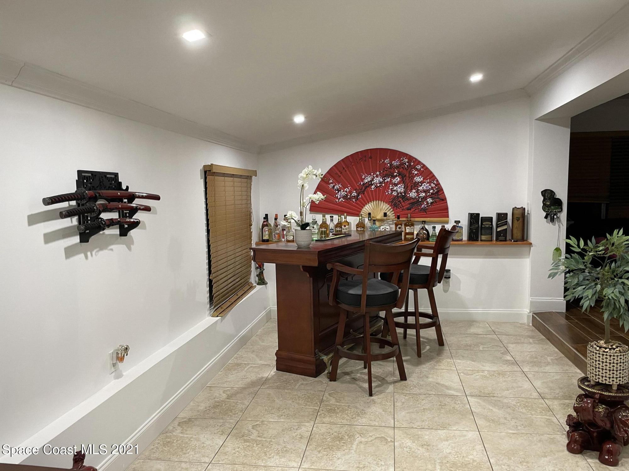 2450 Allan Adale Road Melbourne, FL 32935 - Photo 17 of 29 fam. room bar long view