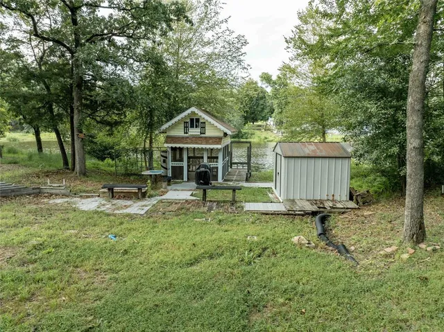 a view of a house with backyard and sitting area