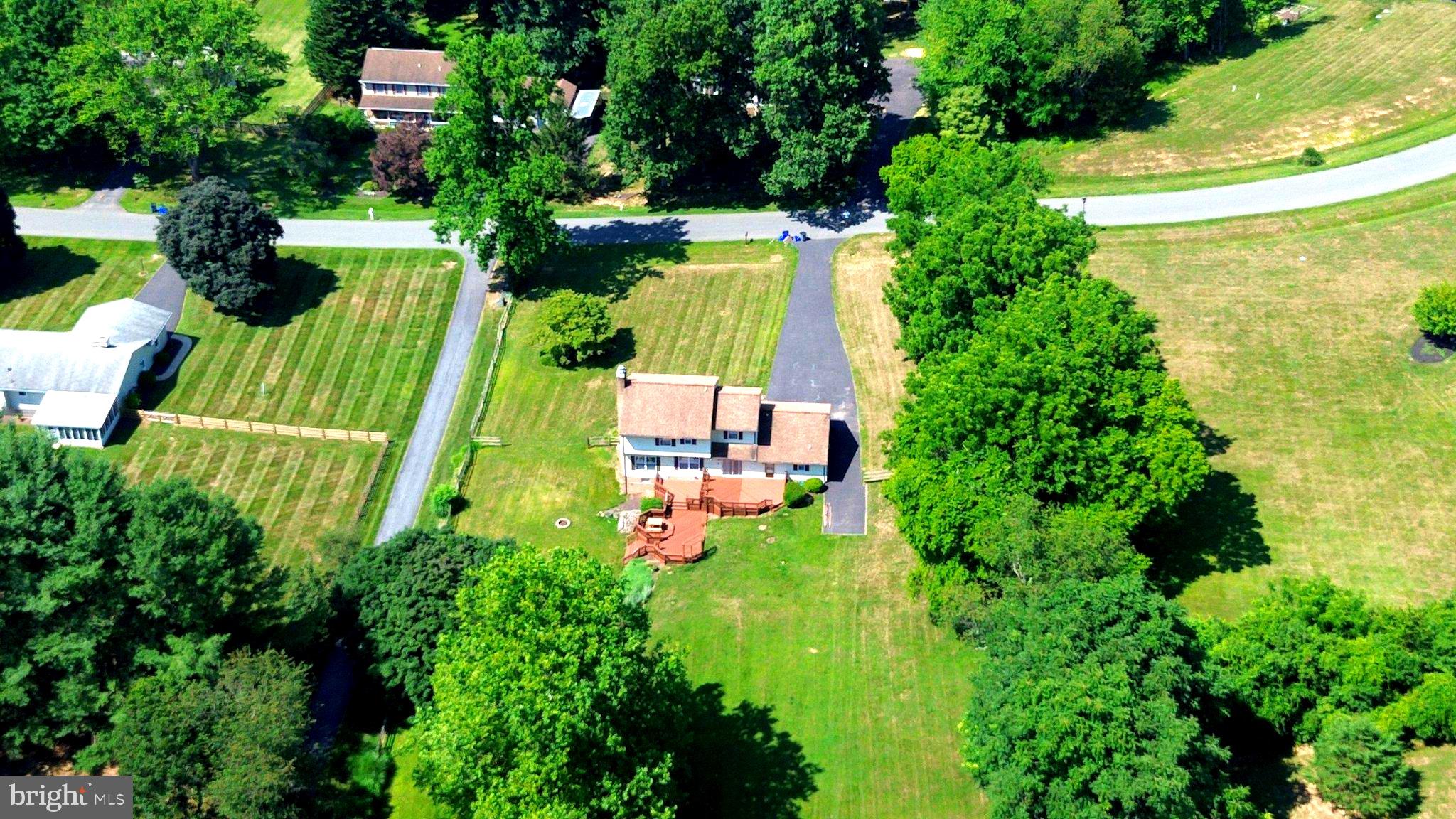 24513 Hanson Road Laytonsville, MD 20882 - Photo 3 of 3 Serene home amidst lush greenery.