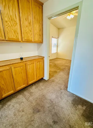 a view of a room with wooden floor and cabinet