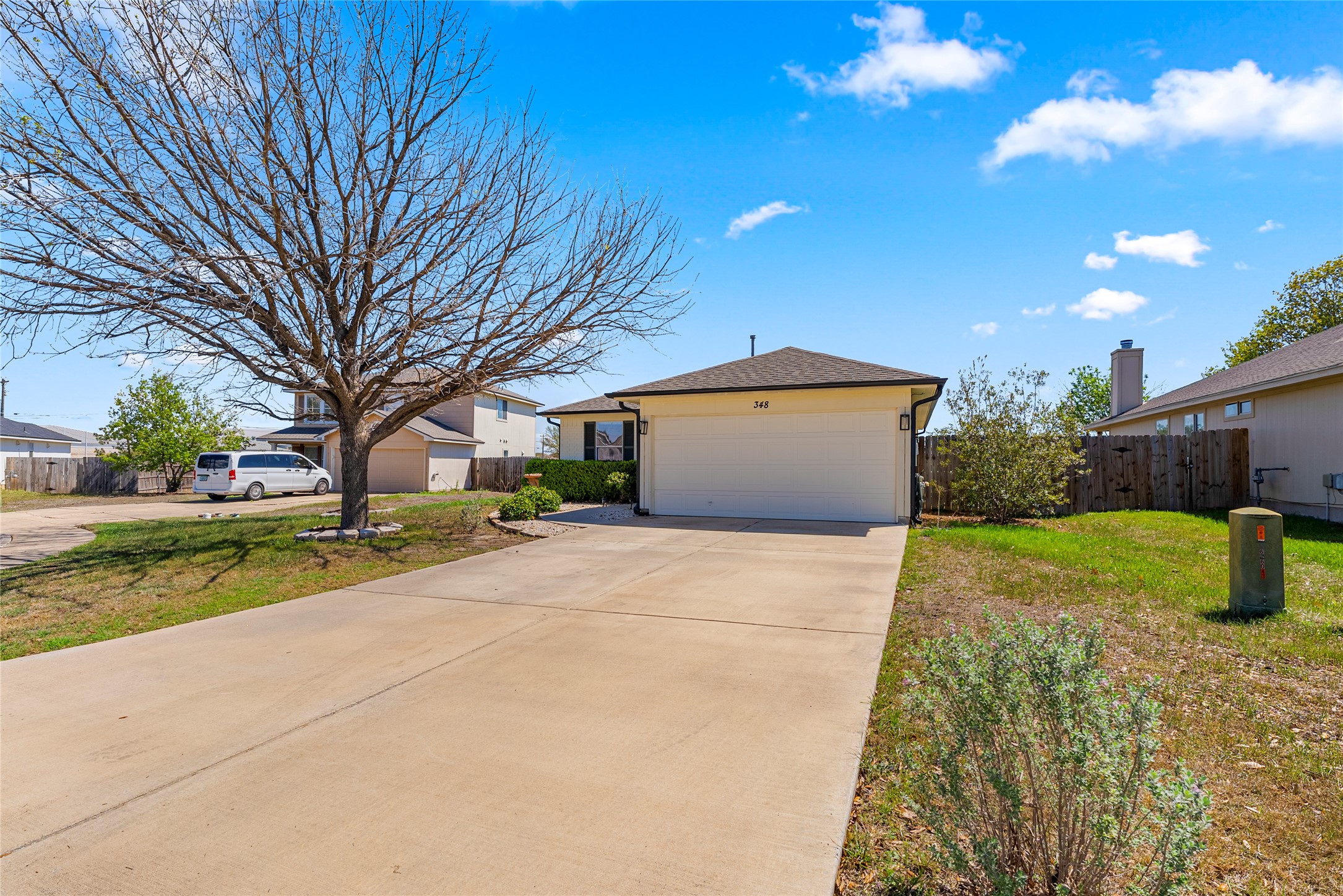 348 Atlantis Kyle, TX 78640 - Photo 1 of 17 View of front of home featuring concrete driveway, an attached garage, and a residential view