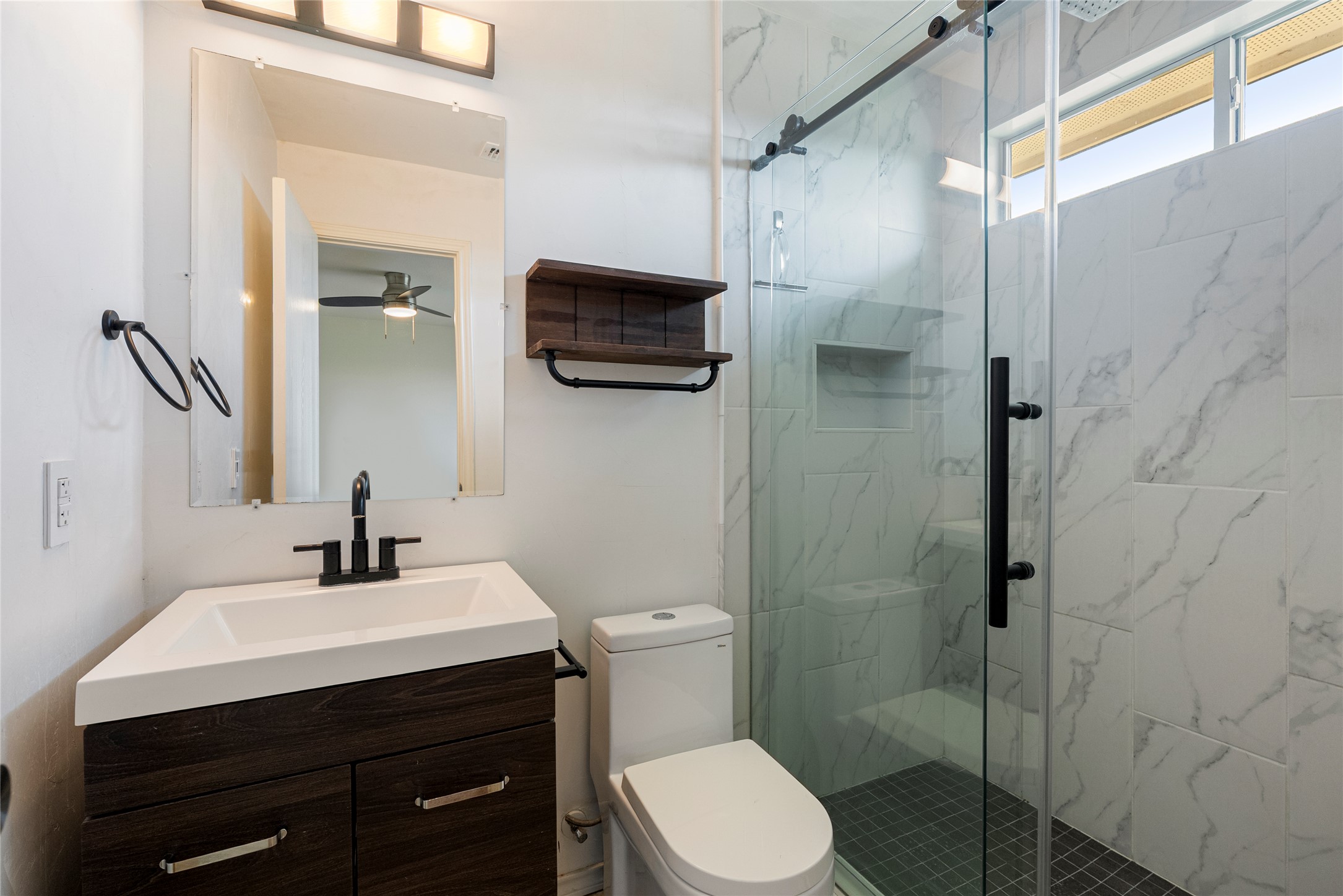 348 Atlantis Kyle, TX 78640 - Photo 14 of 17 Full bath featuring vanity, a marble finish shower, and a ceiling fan