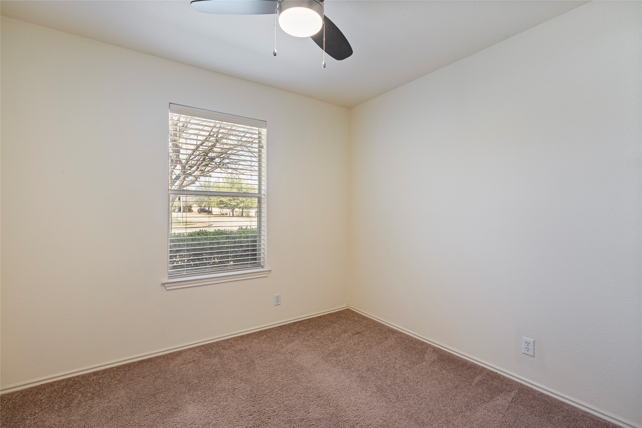 348 Atlantis Kyle, TX 78640 - Photo 5 of 17 Spare room featuring dark colored carpet and a ceiling fan