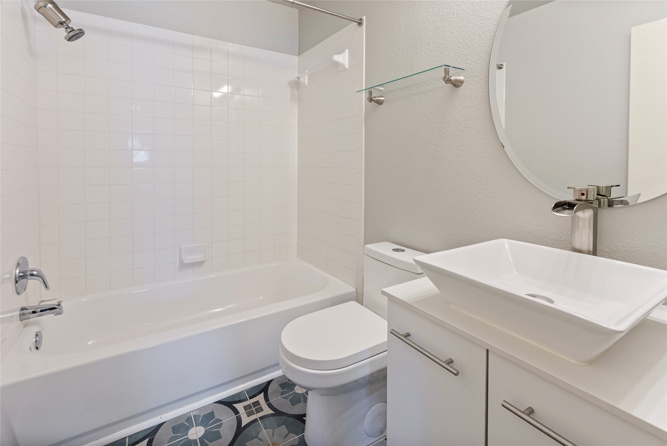 348 Atlantis Kyle, TX 78640 - Photo 9 of 17 Full bath with a textured wall, vanity, and tub / shower combination