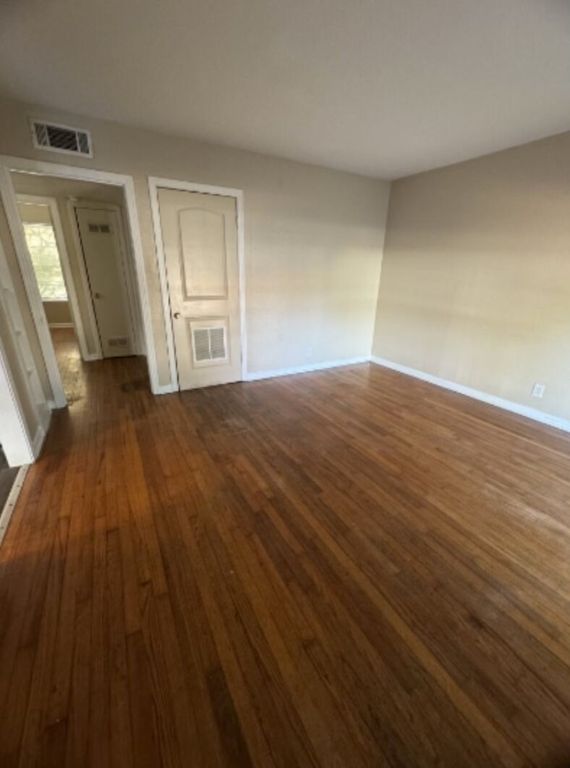 203 North Street, Unit A Kyle, TX 78640 - Photo 2 of 8 a view of empty room with wooden floor and fan
