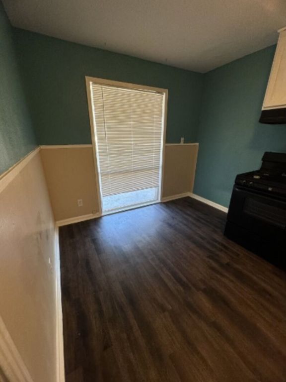 203 North Street, Unit A Kyle, TX 78640 - Photo 4 of 8 a view of an empty room and wooden floor