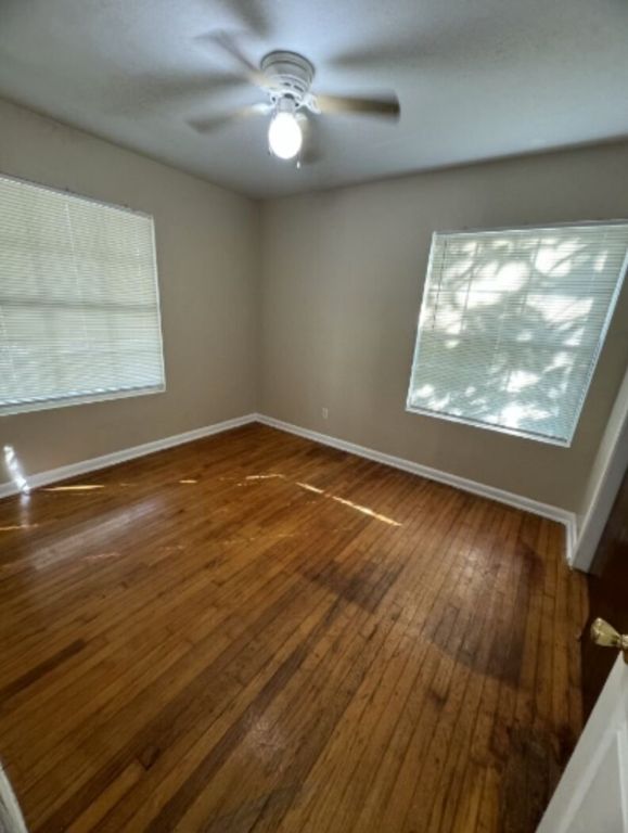 203 North Street, Unit A Kyle, TX 78640 - Photo 8 of 8 an empty room with wooden floor and windows