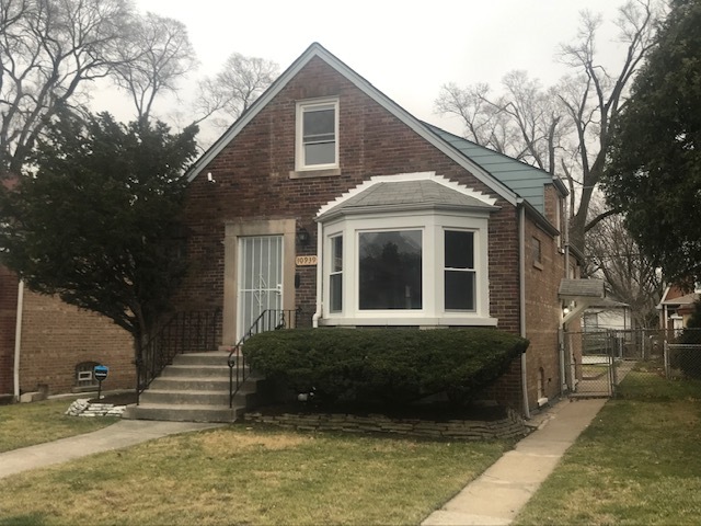 10939 South Normal Avenue Chicago, IL 60628 - Photo 1 of 10 a front view of a house with a yard