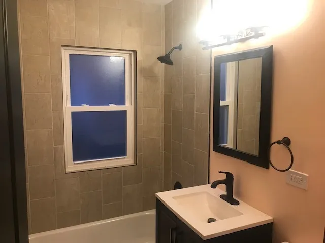 a bathroom with a sink mirror and vanity