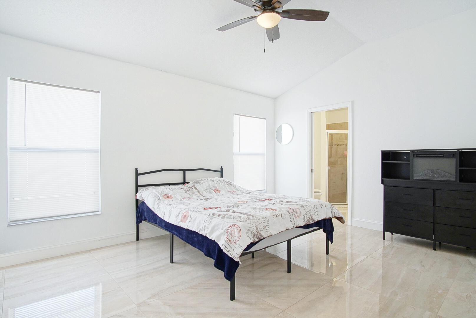 2619 Southwest Fair Isle Road Port St. Lucie, FL 34987 - Photo 11 of 33 a bedroom with a bed and a chandelier