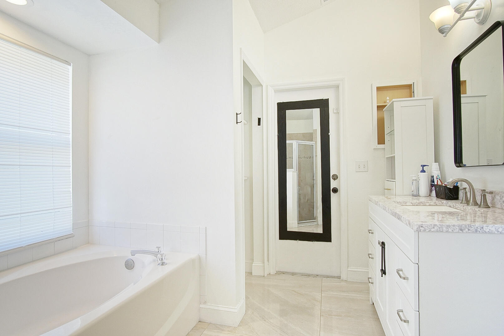 2619 Southwest Fair Isle Road Port St. Lucie, FL 34987 - Photo 14 of 33 a bathroom with a granite countertop sink and a bathtub