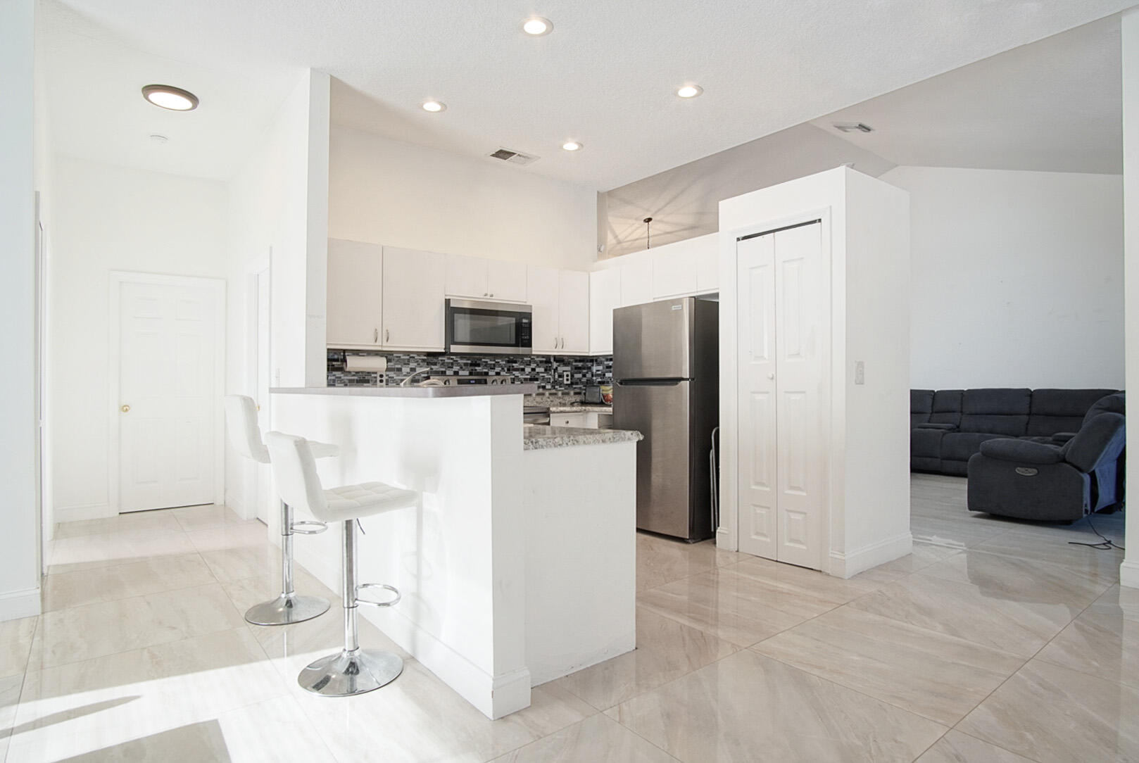 2619 Southwest Fair Isle Road Port St. Lucie, FL 34987 - Photo 2 of 33 a kitchen with a refrigerator a stove and a cabinets