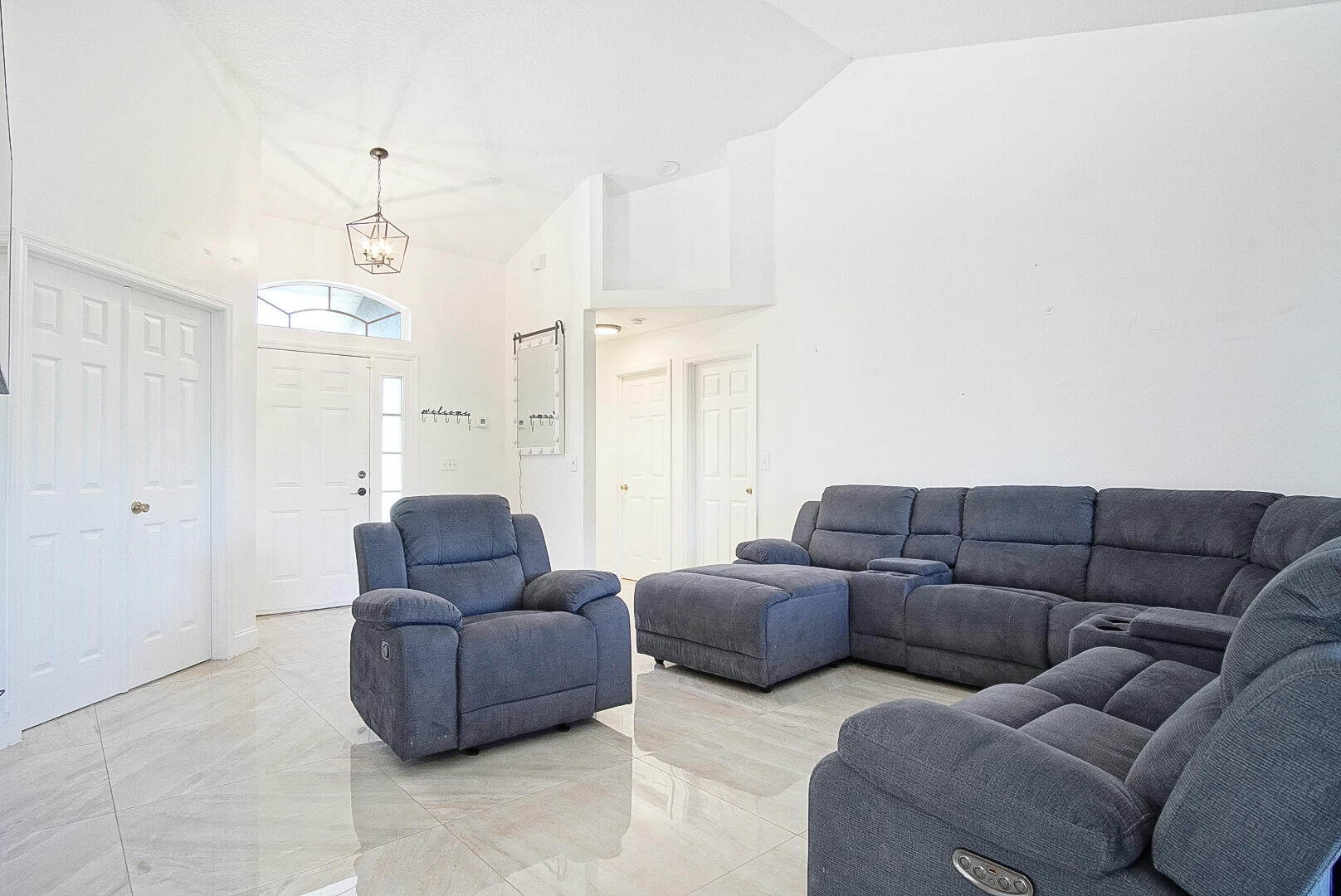 2619 Southwest Fair Isle Road Port St. Lucie, FL 34987 - Photo 22 of 33 a living room with furniture and a chandelier