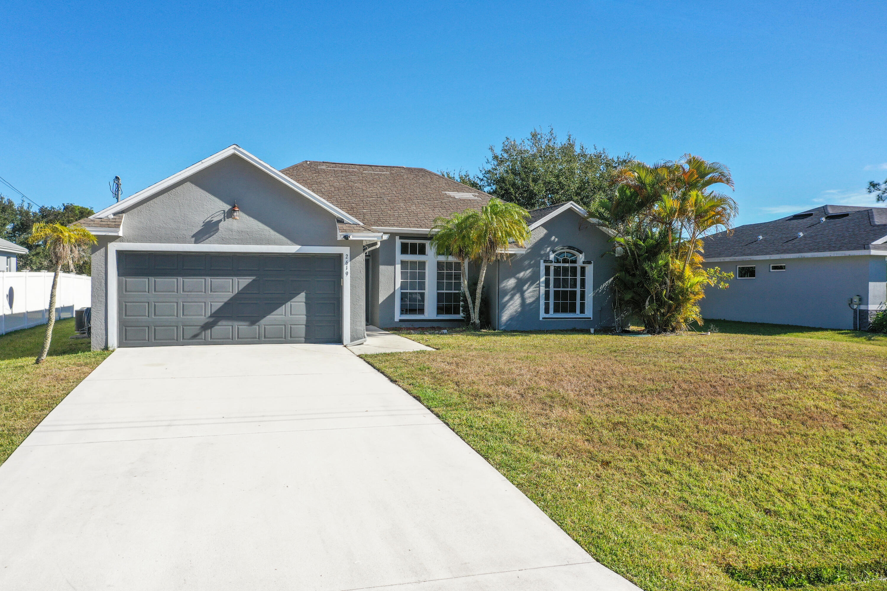 2619 Southwest Fair Isle Road Port St. Lucie, FL 34987 - Photo 33 of 33 a front view of a house with a yard and garage