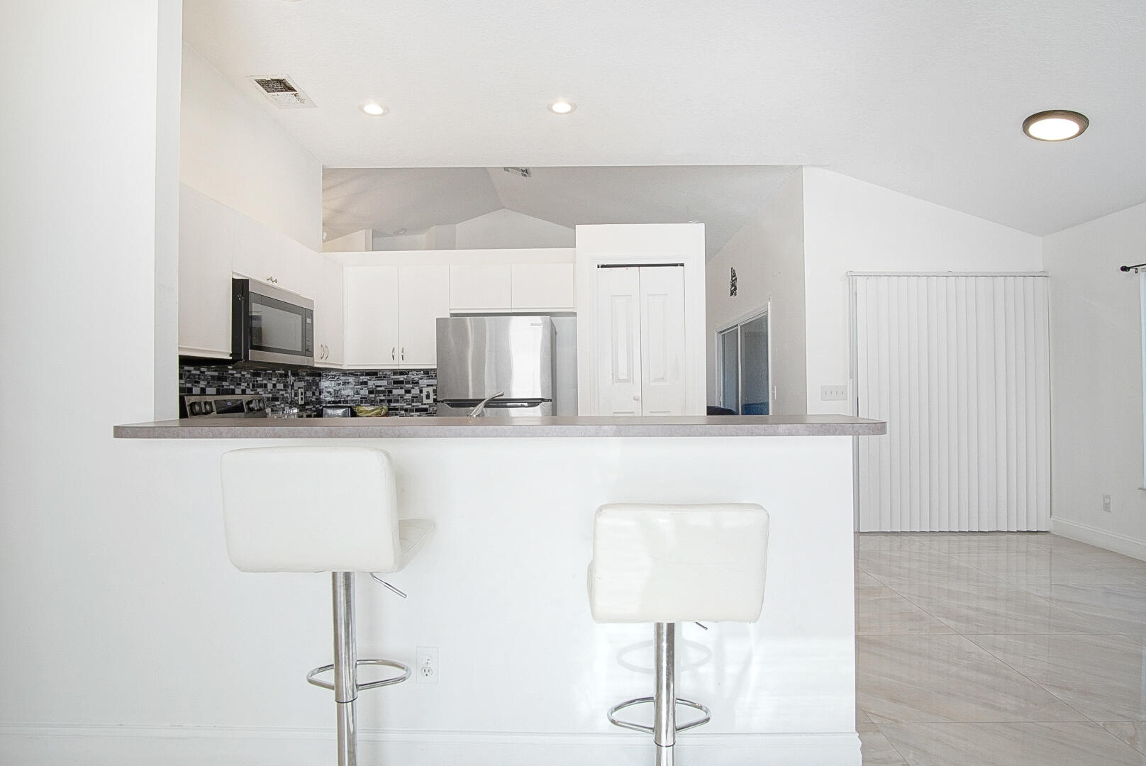 2619 Southwest Fair Isle Road Port St. Lucie, FL 34987 - Photo 5 of 33 a bathroom with a sink and a mirror