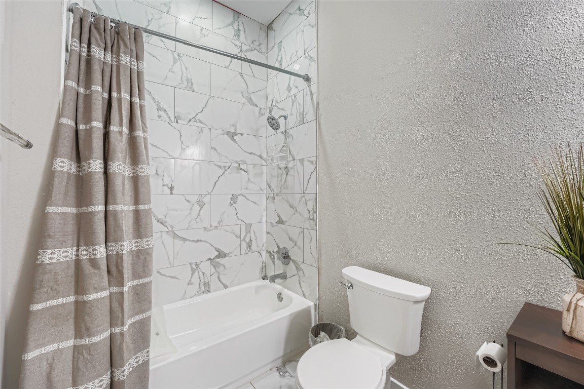 149 Arosa Drive Elgin, TX 78621 - Photo 33 of 40 a white toilet sitting next to a bath tub