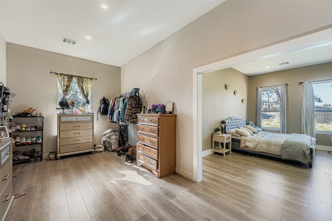 149 Arosa Drive Elgin, TX 78621 - Photo 37 of 40 a bedroom with furniture and a wooden floor