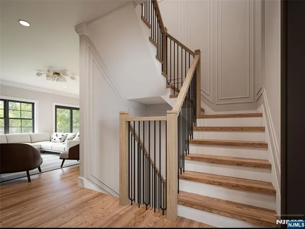 a view of entryway and hall with wooden floor
