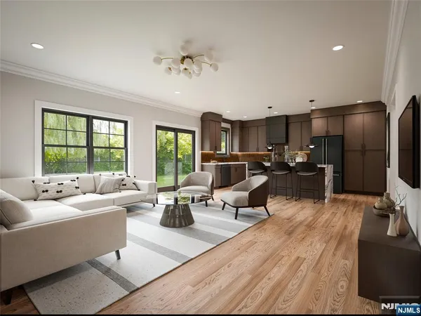a living room with furniture kitchen view and a large window