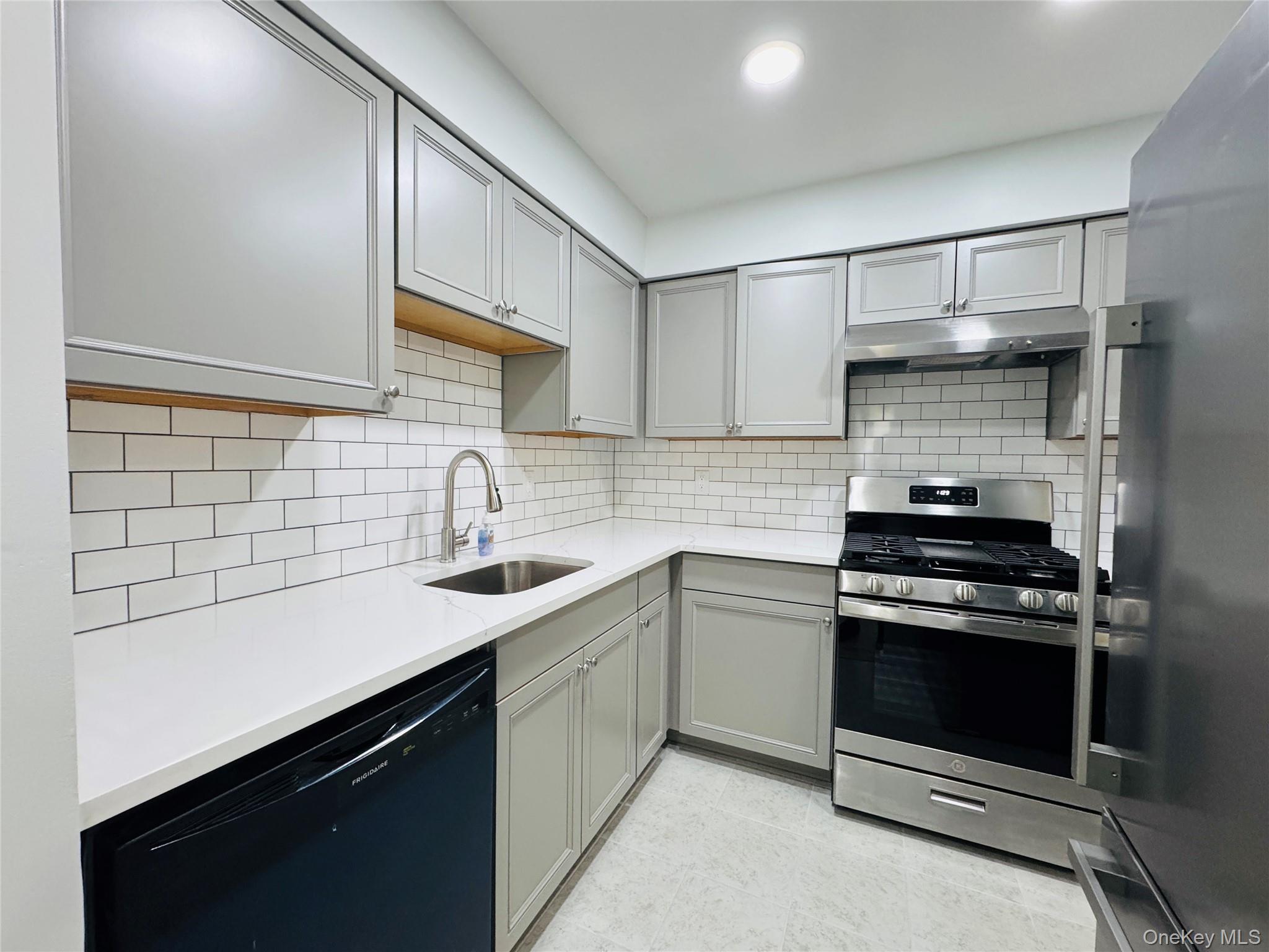 1 Ruth Court Middletown, NY 10940 - Photo 3 of 22 a kitchen with a sink stove and cabinets