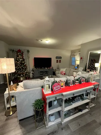 a bedroom with furniture and a flat screen tv