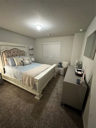 a bedroom with bed and a couch