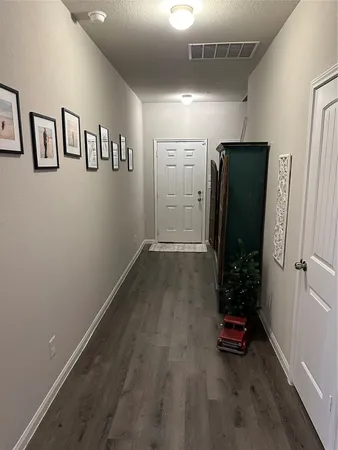 an empty room with closet and wooden floor