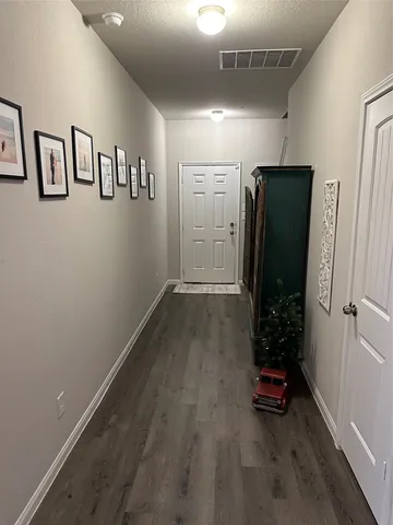 an empty room with closet and wooden floor