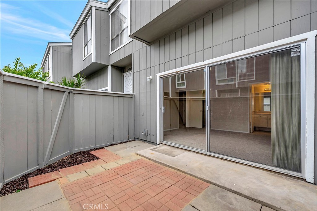 2670 West Segerstrom Avenue, Unit F Santa Ana, CA 92704 - Photo 19 of 28 a view of backyard with large windows